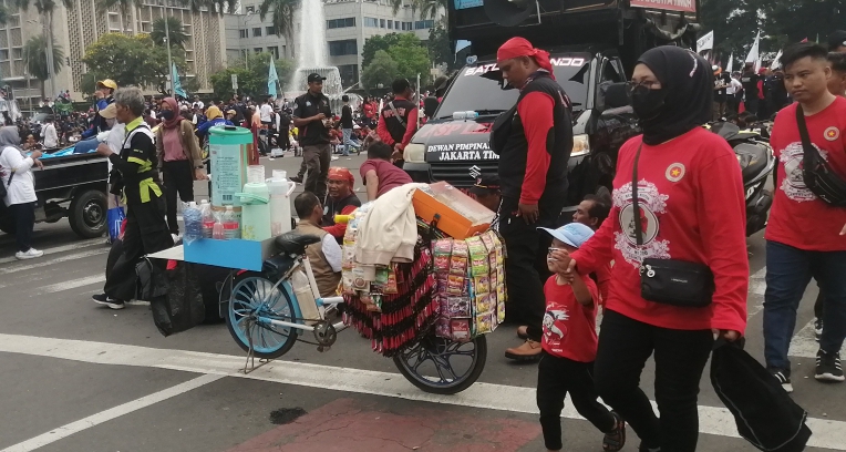 Pedagang kopi keliling di lokasi unjuk rasa May Day 2024 di Patung Kuda (SinPo.id/ Tio Pirnando)