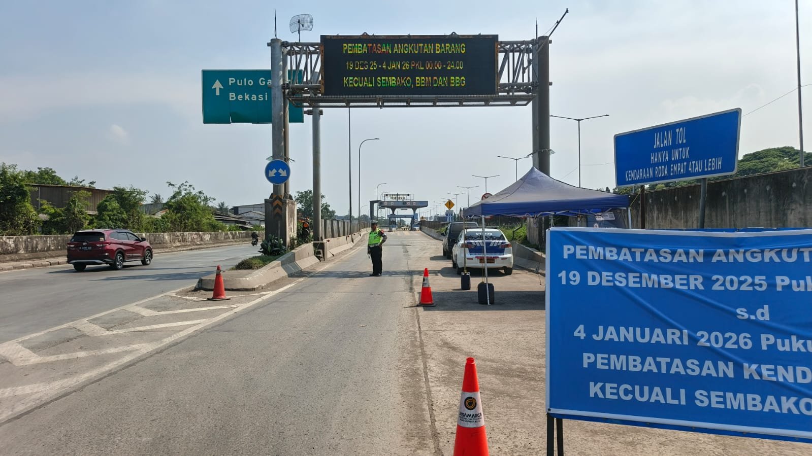 Anggota PJR Polda Metro Jaya saat melakukan pembatasan truk sumbu 3 (SinPo.id/TMCPoldaMetro)