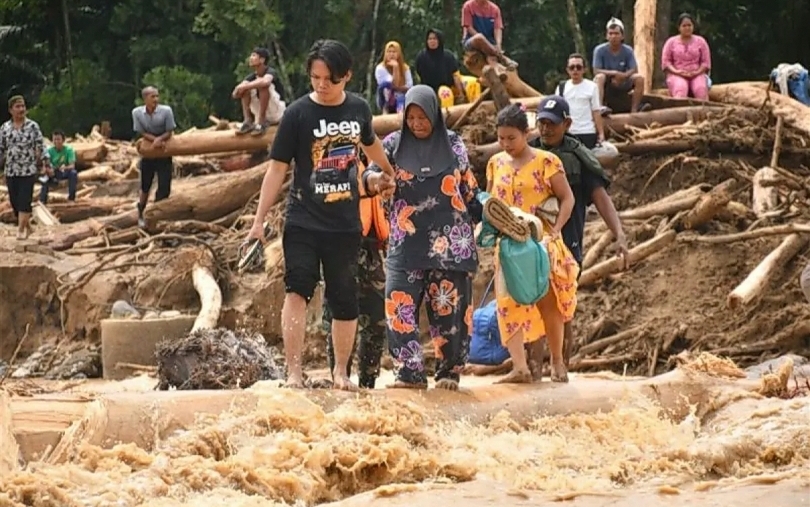 Warga Tapanuli Selatan melintasi jembatan sementara (SinPo.id/Dok. Puspen TNI)
