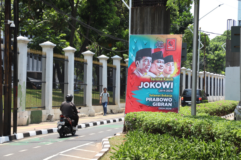 Baliho ucapan terima kasih Jokowi menurut lembaga Survei Indikator Politik 80 persen masyarakat puas dengan kinerja Jokowi selama 10 tahun (Ashar/SinPo.id)