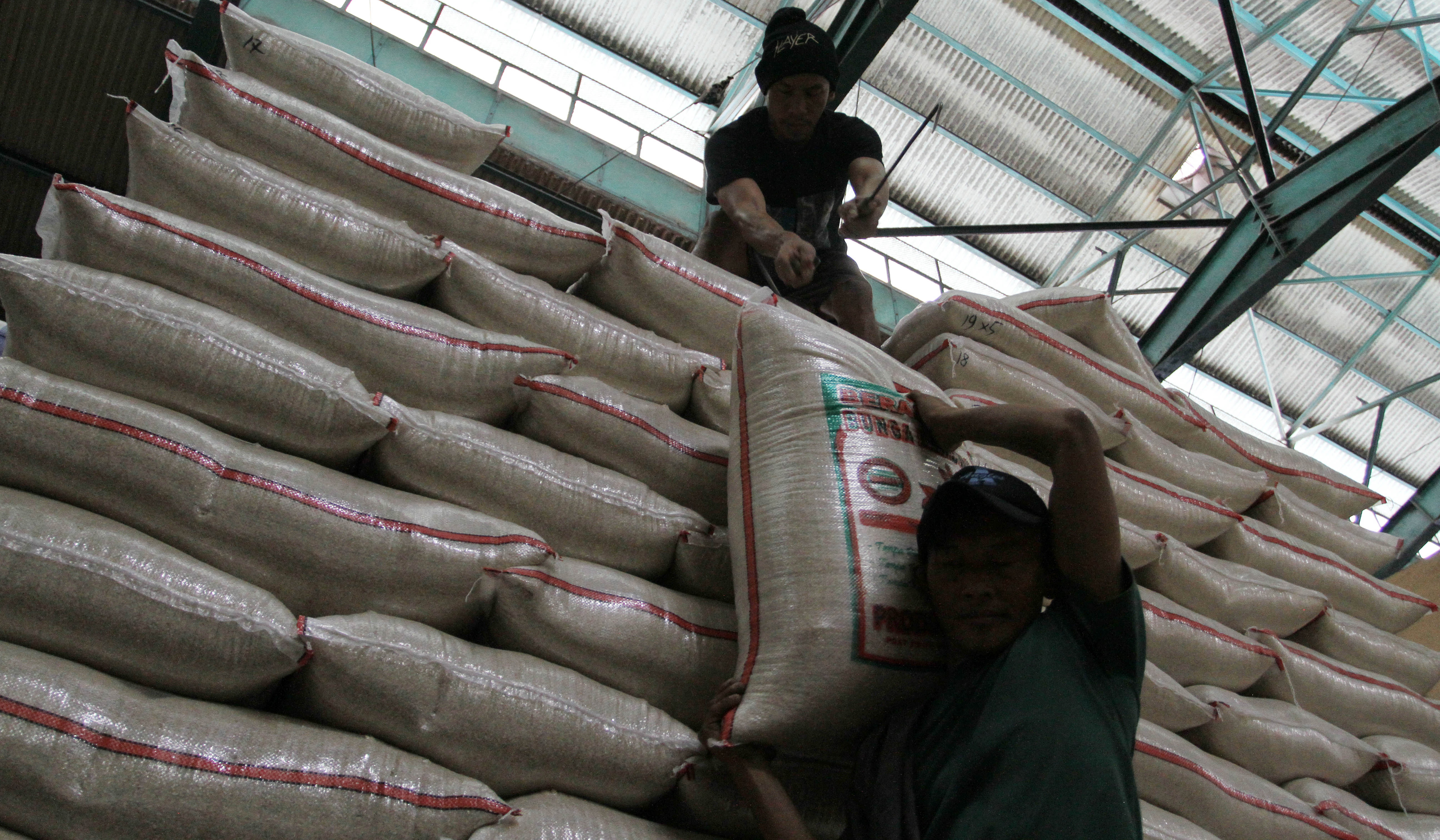 Pembeli mengecek kualitas beras di Pasar Induk Beras Cipinang. (Agus Priatna/SinPo.id)