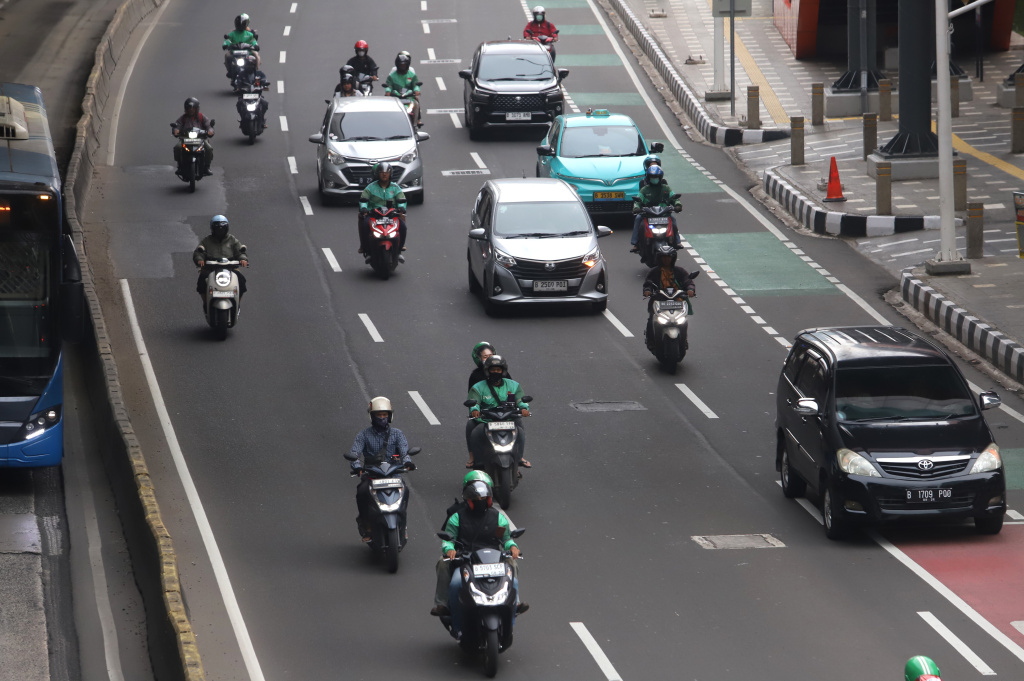 Pemerintah memberikan paket stimulus ekonomi 8+4+5 jaminan sosial untuk ojek online mendapatkan jaminan JKK,JKM dan JHT (Ashar/SinPo.id)