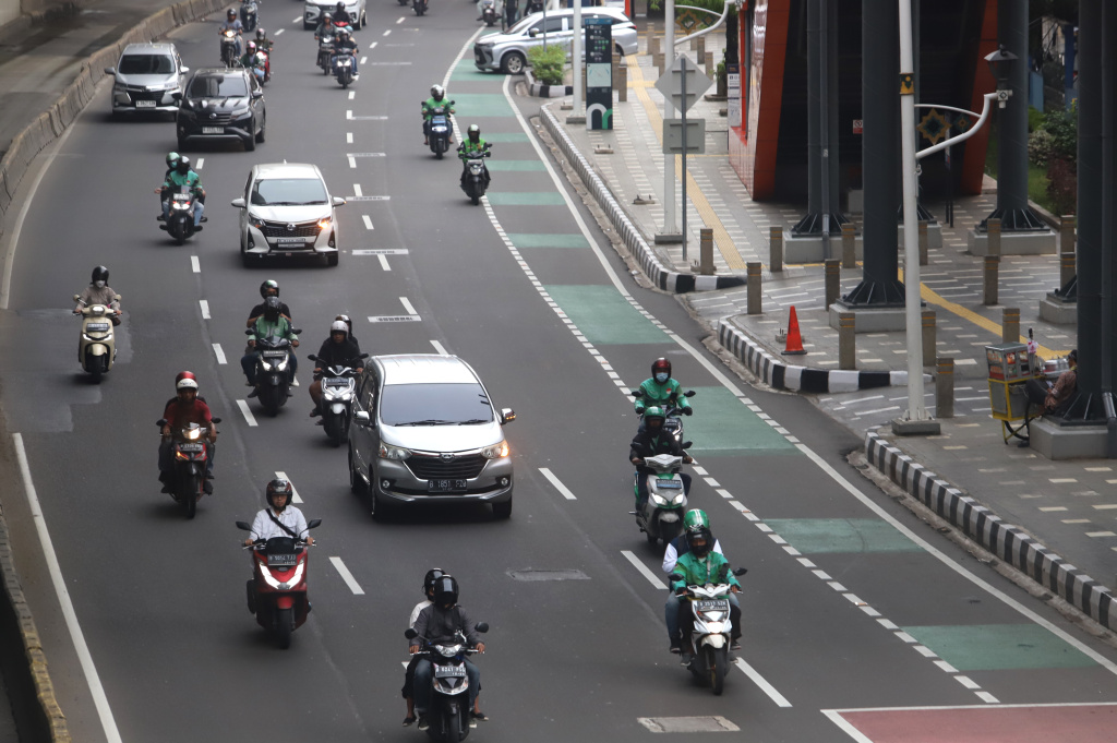 Pemerintah memberikan paket stimulus ekonomi 8+4+5 jaminan sosial untuk ojek online mendapatkan jaminan JKK,JKM dan JHT (Ashar/SinPo.id)