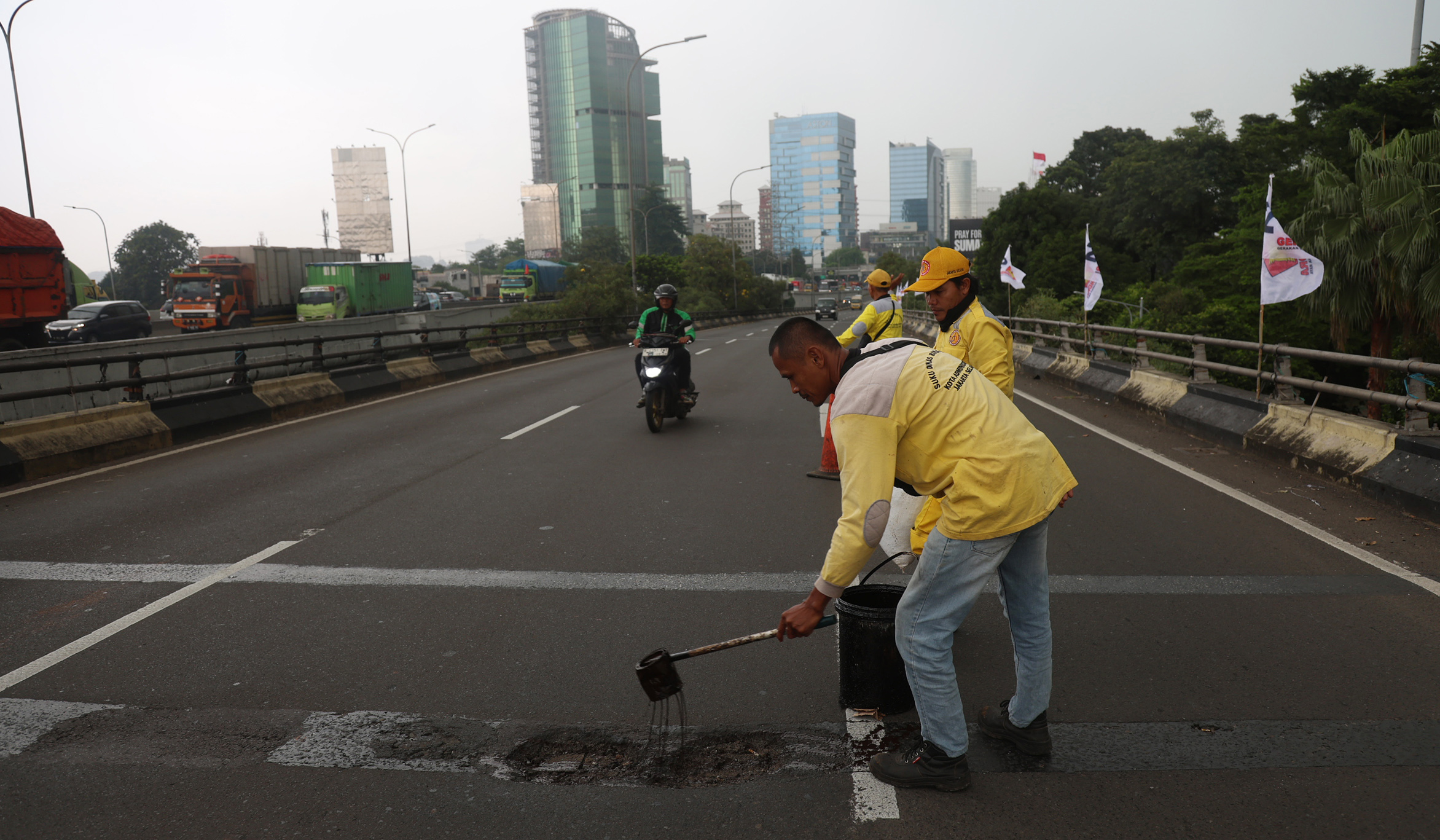 Perbaikan jalan berlubang. (Agus Priatna/SinPo.id)