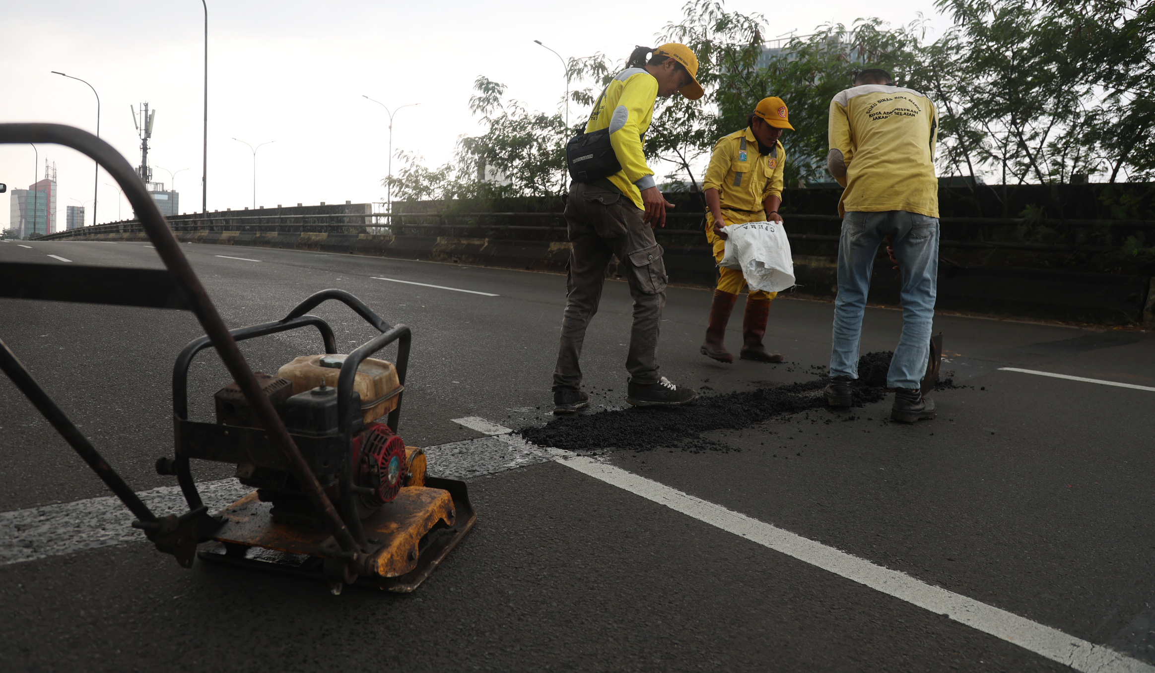 Perbaikan jalan berlubang. (Agus Priatna/SinPo.id)