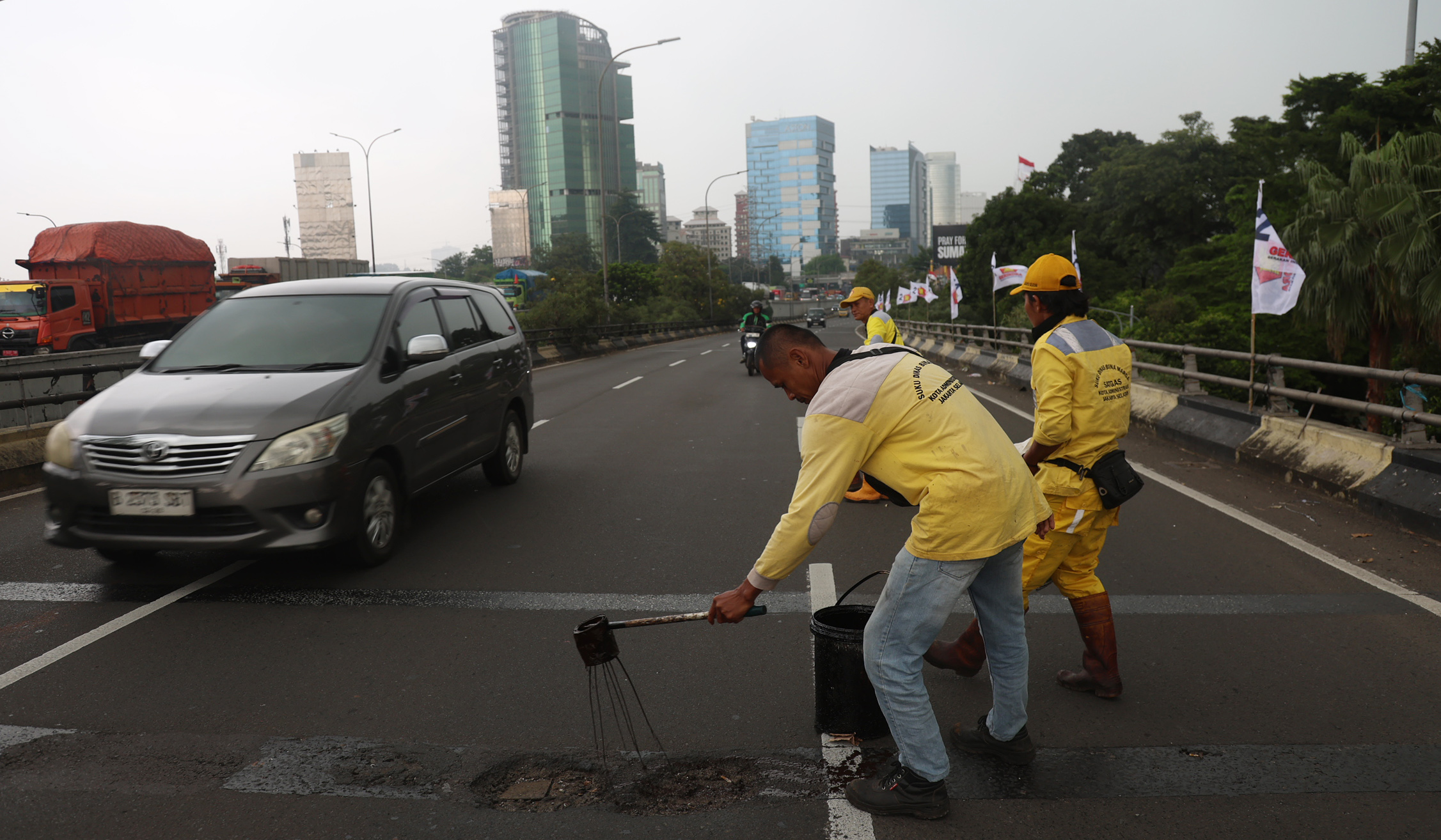Perbaikan jalan berlubang. (Agus Priatna/SinPo.id)