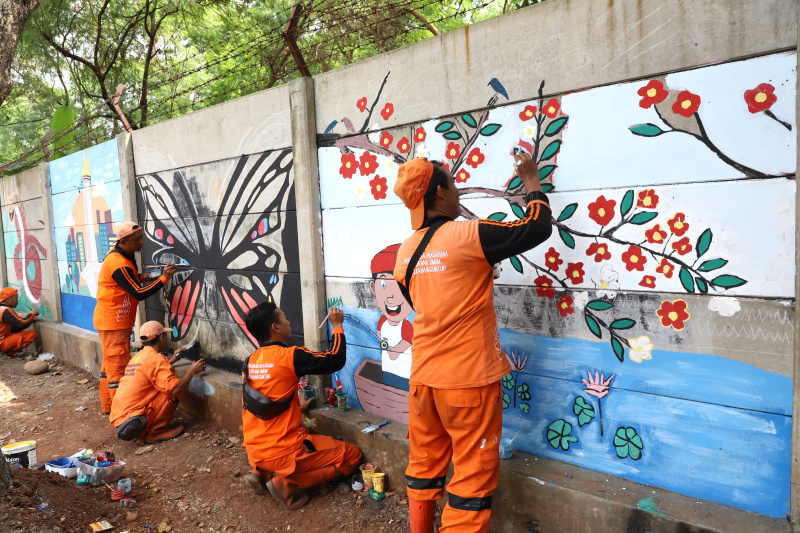 Petugas PPSU Guntur Jakarta Selatan membuat mural untuk menyambut Hari Kemerdekaan Republik Indonesia ke-79 (Ashar/SinPo.id)